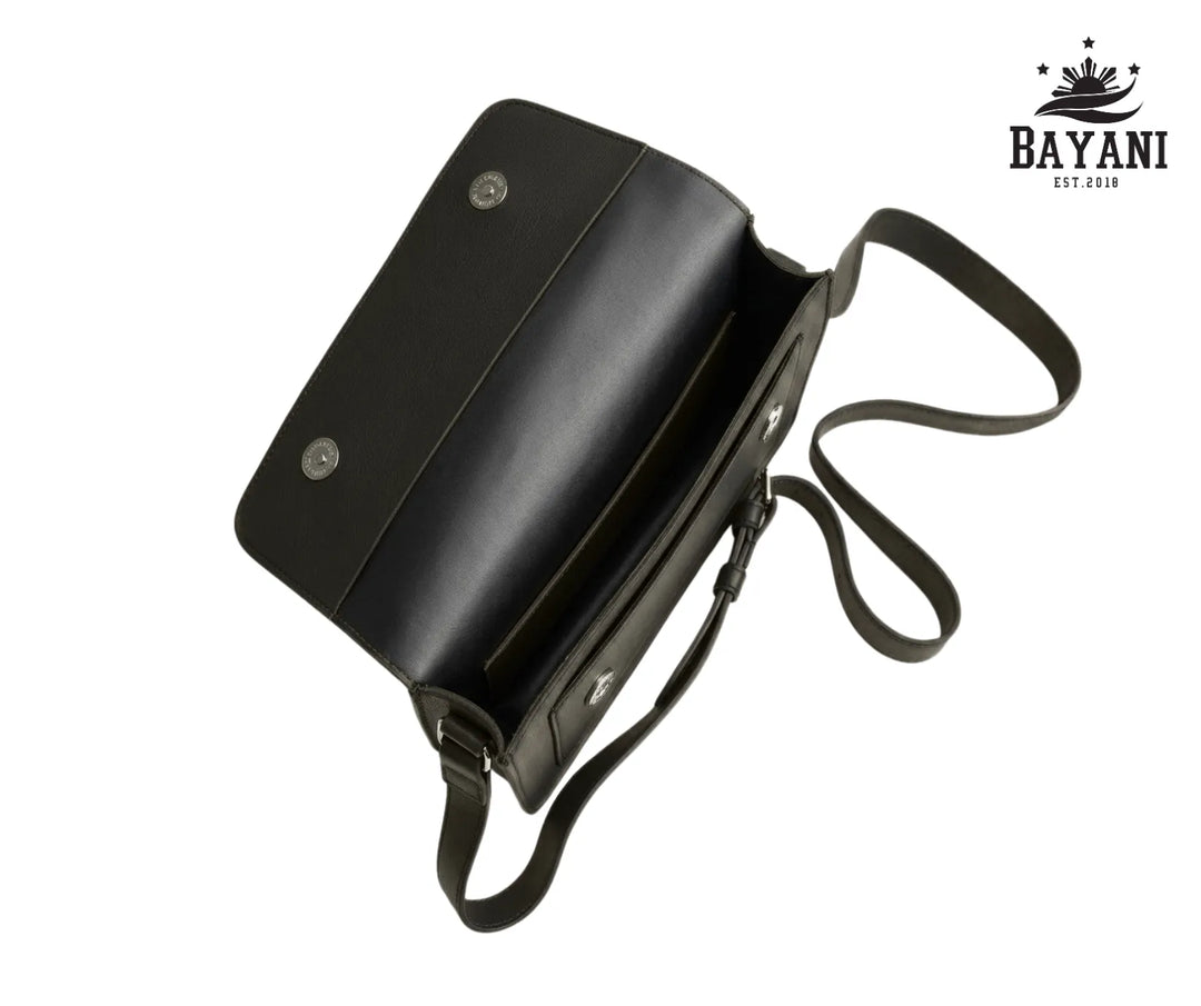 Black leather crossbody bag with a strap on a white background, featuring the Bayani brand.
