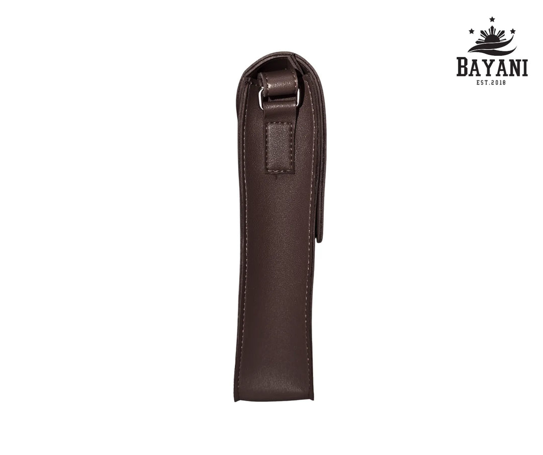 Brown leather crossbody bag on a white background with Bayani logo.
