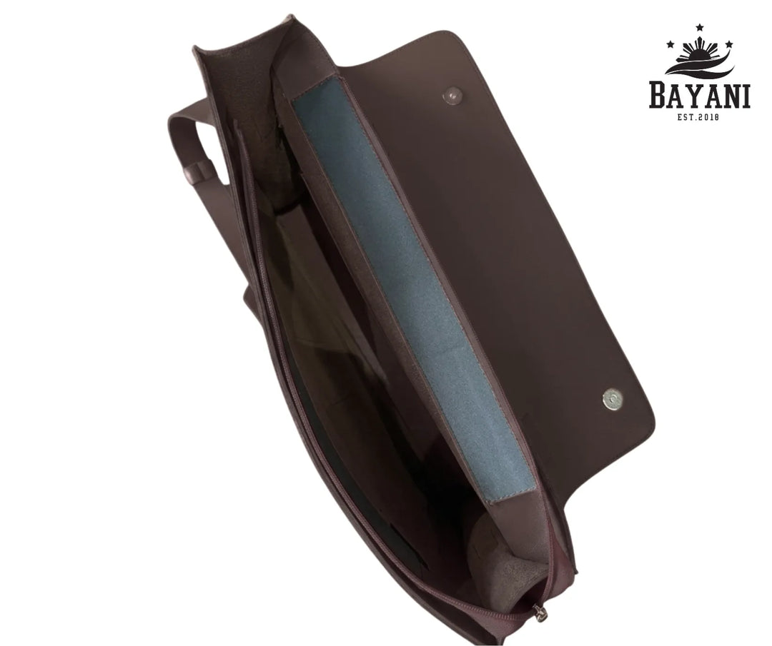 Brown leather laptop bag with blue interior on a white background, featuring Bayani logo.
