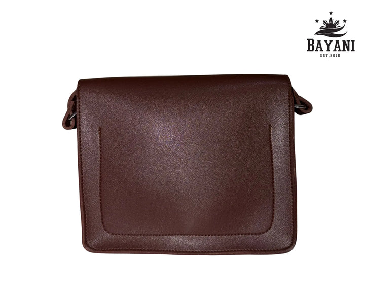 Brown leather bag on a white background with Bayani logo.
