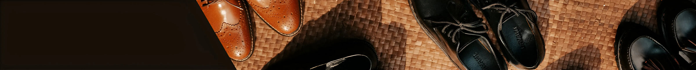 Pair of brown leather shoes on a textured surface