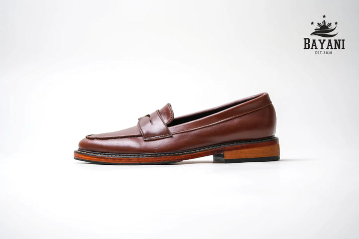 Brown loafer shoe on a white background with Bayani logo.
