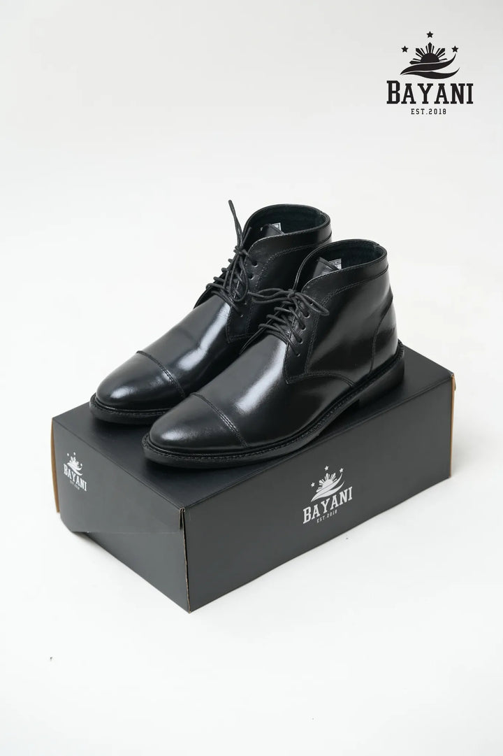 Black dress shoes on a black box with Bayani logo on a white background


