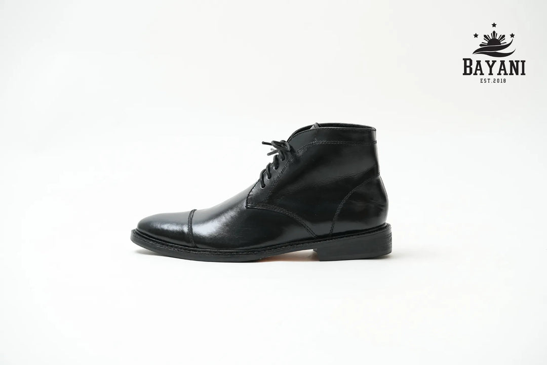 Black leather boot on a white background with Bayani logo.

