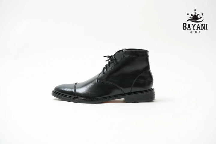 Black leather boot on a white background with Bayani logo.


