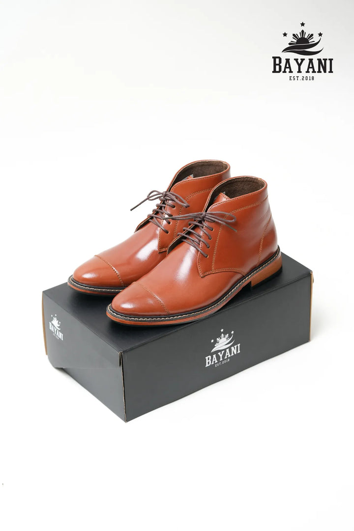 Brown leather shoes on a Bayani branded box with the Bayani logo above.
