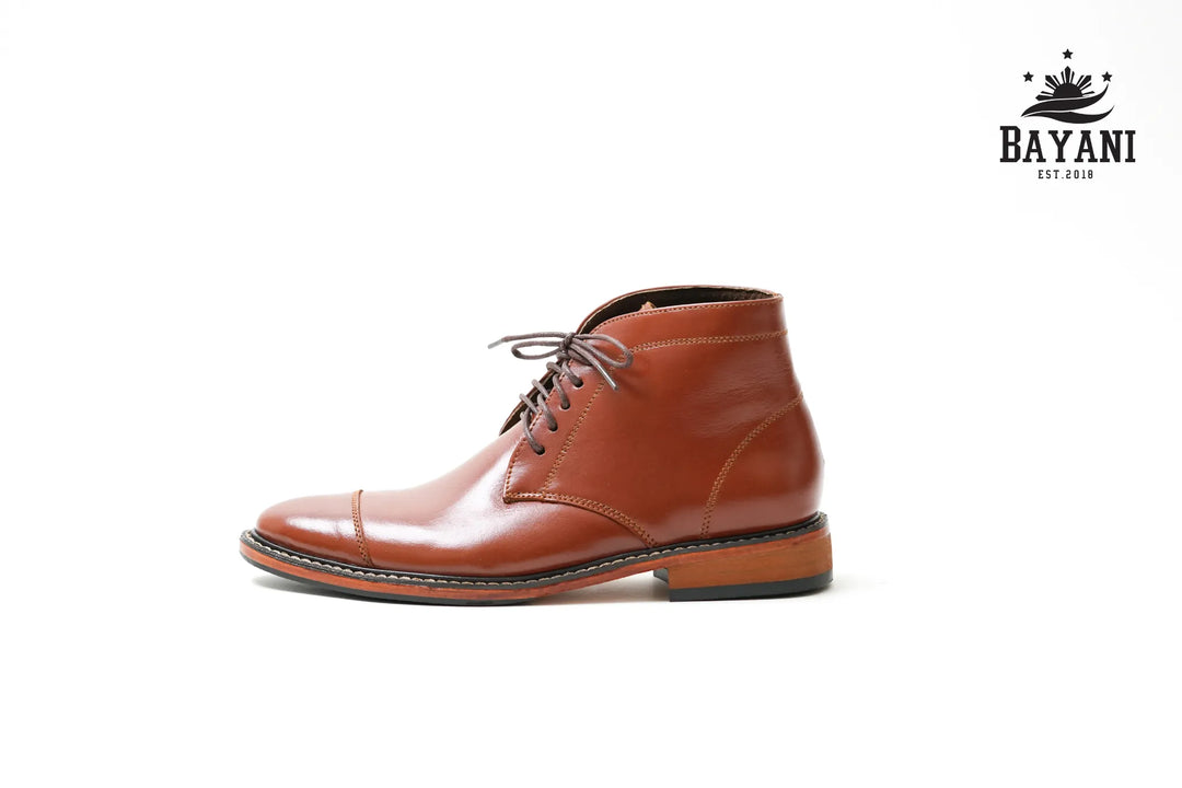 Brown leather boot on a white background with Bayani logo.
