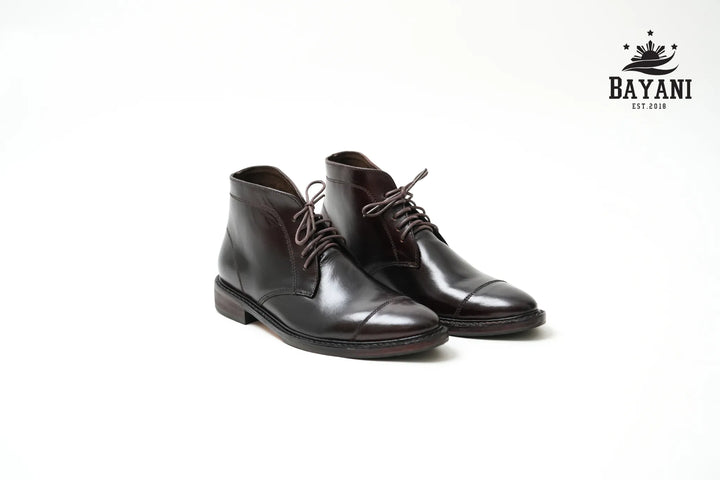 Pair of brown leather shoes on a white background with Bayani logo.

