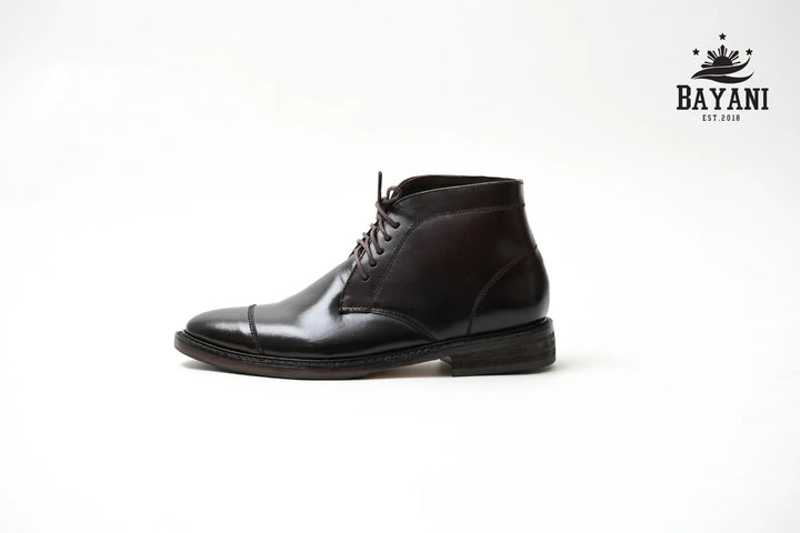 Black leather boot on a white background with Bayani logo.
