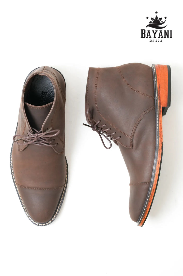 Brown leather shoes with orange sole on a white background, featuring the Bayani brand logo.
