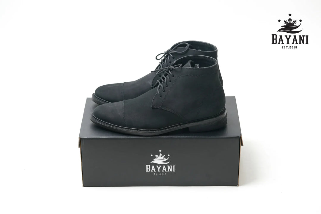 Black dress shoes on a black box with Bayani logo on a white background
