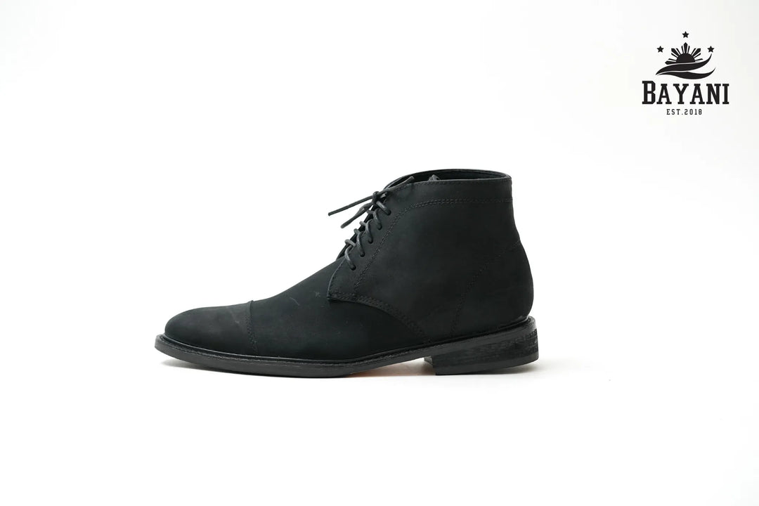 Black leather boot on a white background with Bayani logo.
