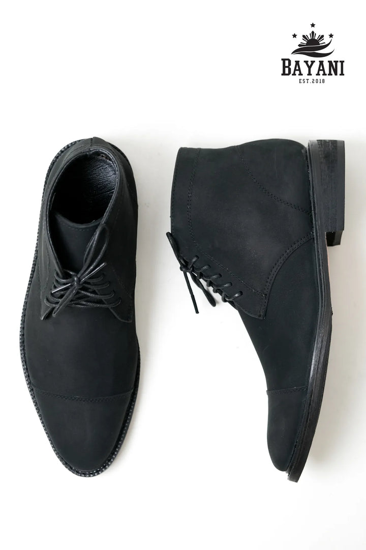 Pair of black dress shoes on a white background with Bayani logo.
