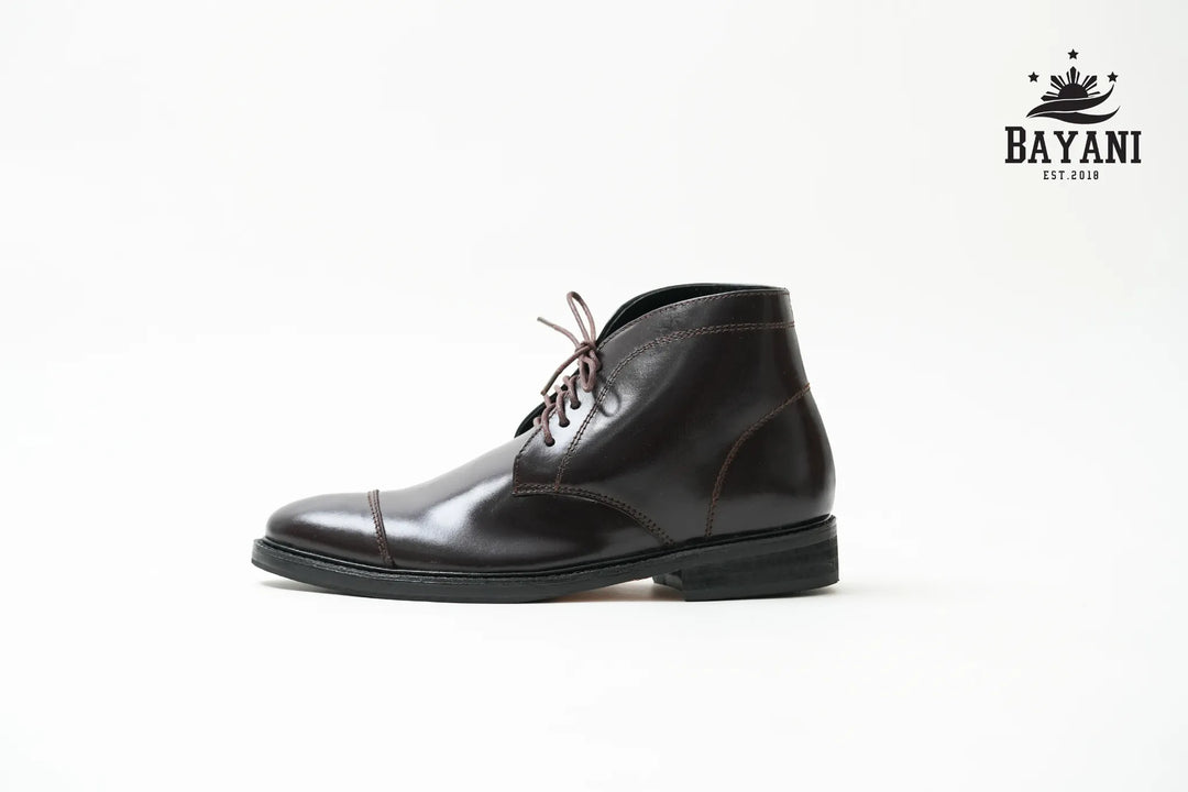 Black leather shoe on a white background with Bayani logo.

