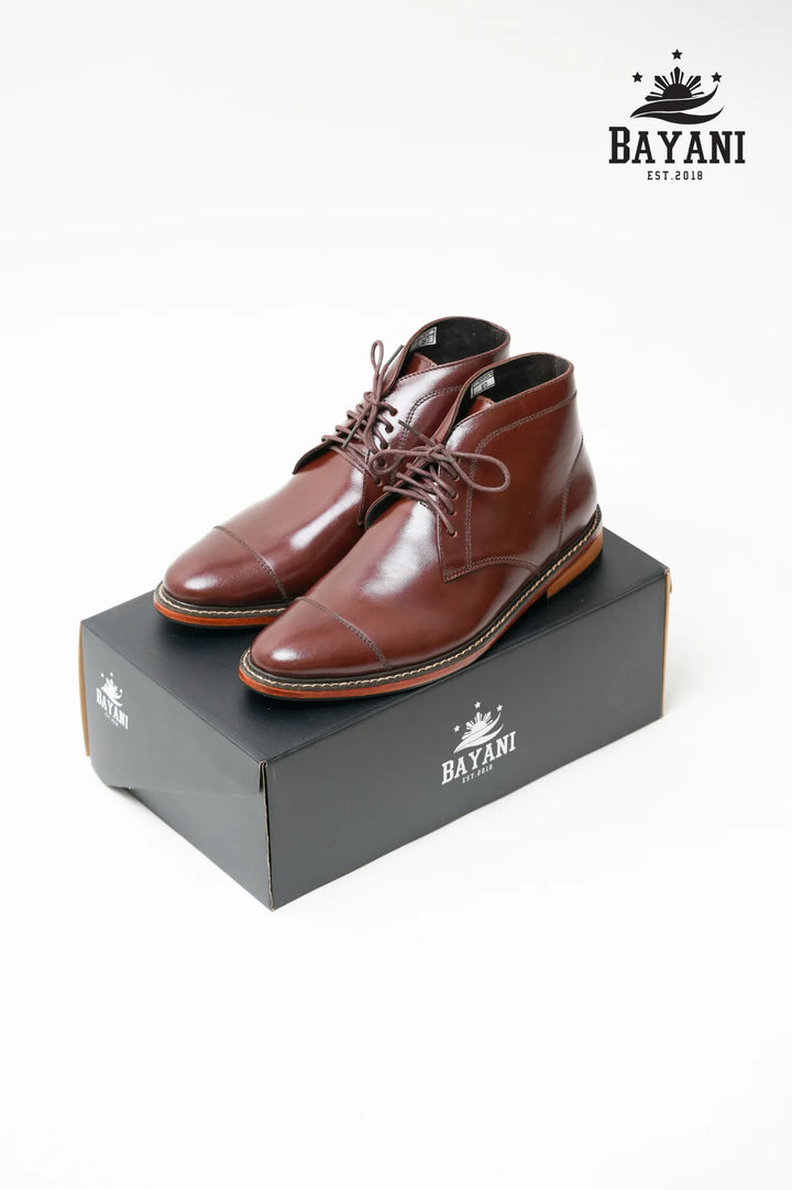 Brown leather shoes on a Bayani branded box with the Bayani logo above.
