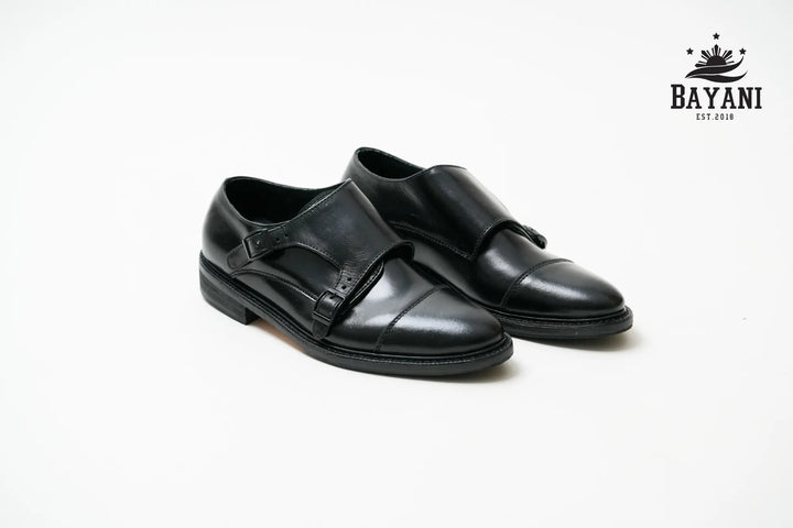 Black dress shoes on a white background with Bayani logo.
