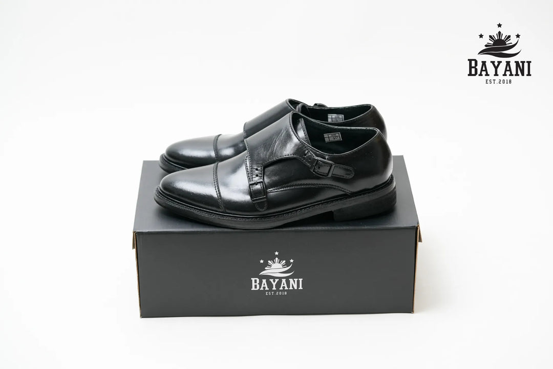 Black leather shoes on a black box with Bayani logo on a white background
