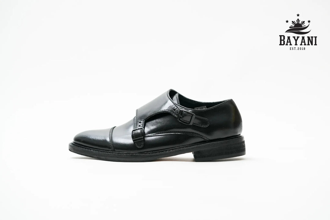Black dress shoe on a white background with Bayani logo.
