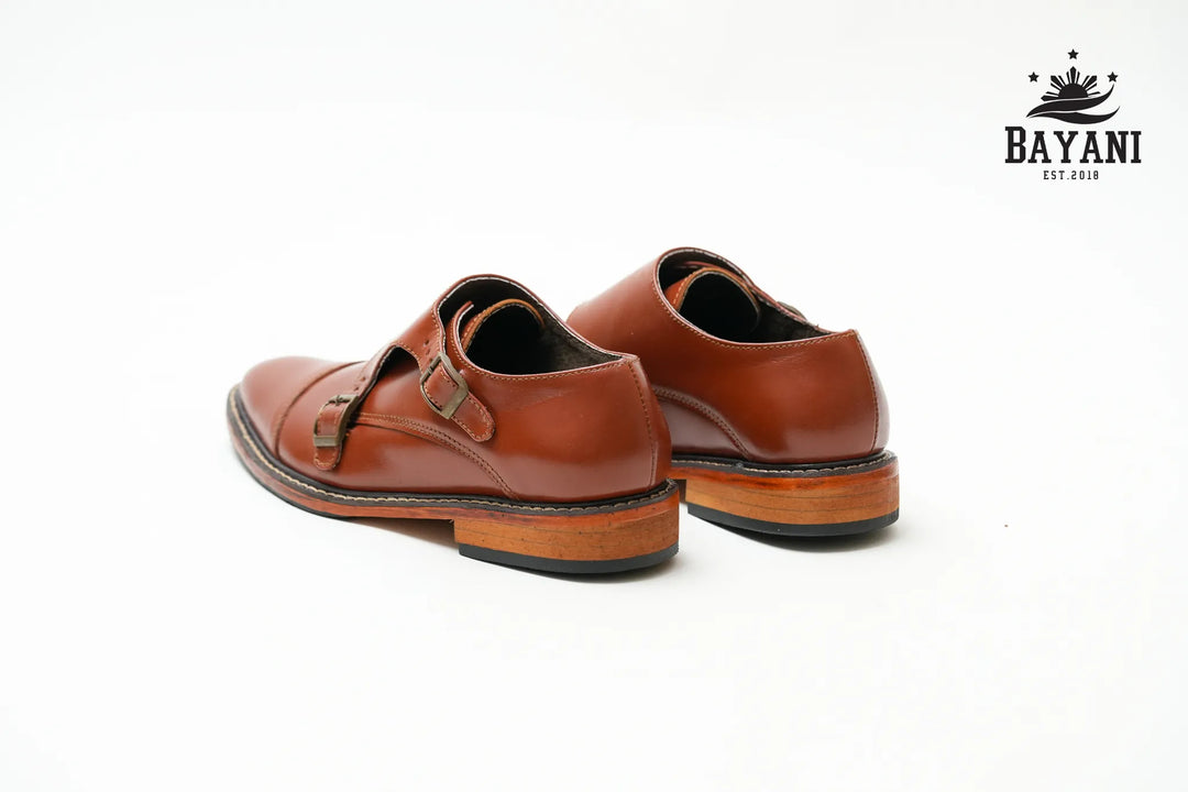 Brown leather shoes with a visible brand logo on a white background
