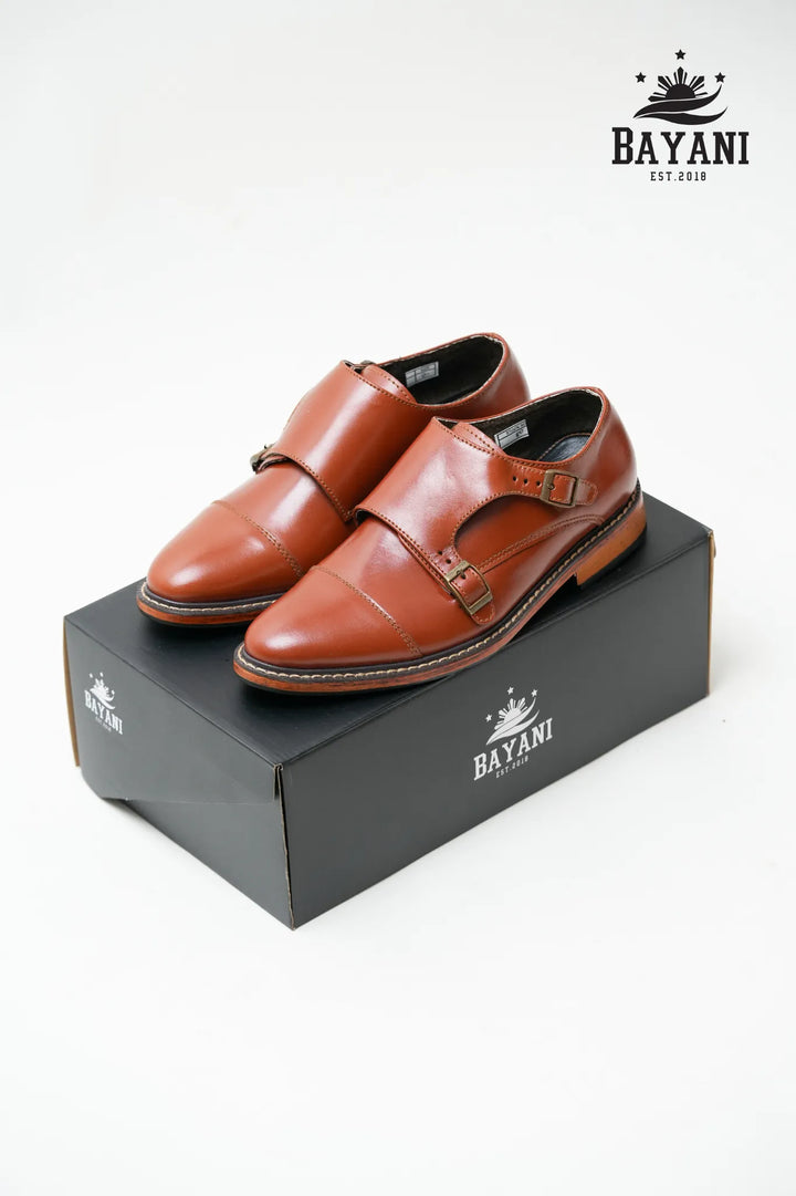 Brown leather shoes on a black Bayani branded box with the Bayani logo above.
