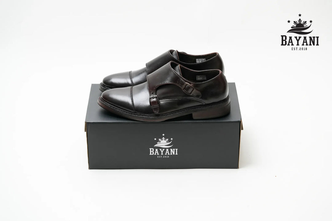 Black shoes on a black box with Bayani logo on a white background
