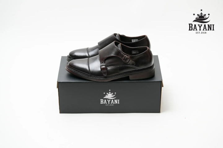 Black shoes on a black box with Bayani logo on a white background
