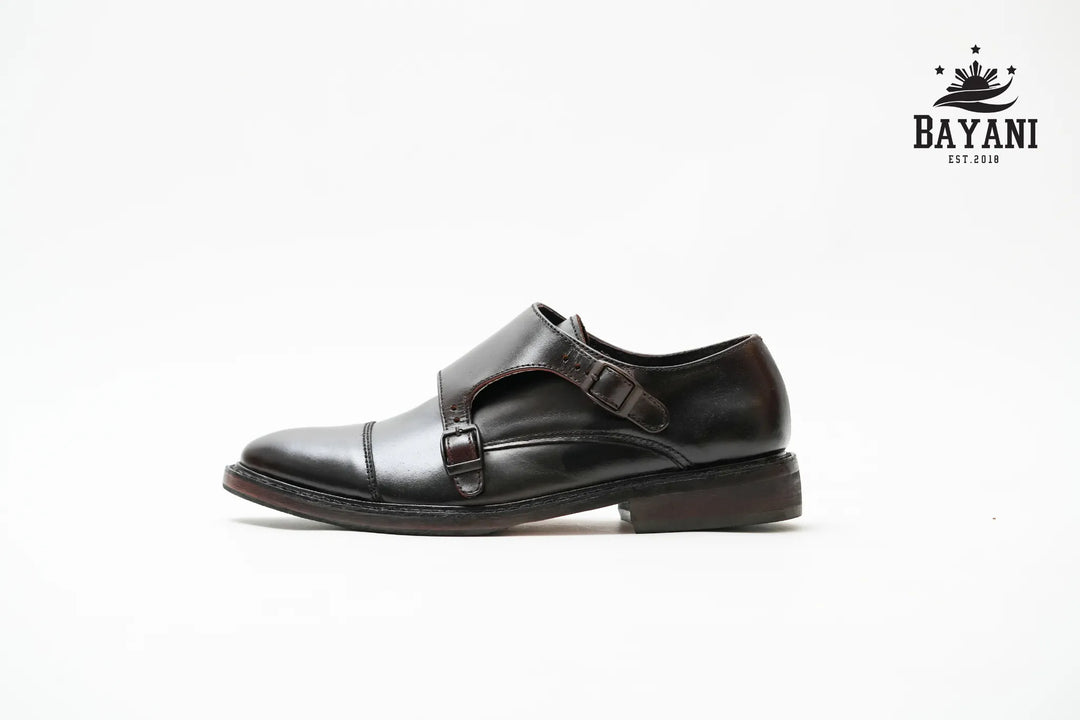 Black dress shoe with a strap on a white background, featuring the Bayani brand logo.
