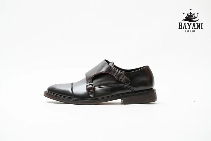Black dress shoe with a strap on a white background, featuring the Bayani brand logo.
