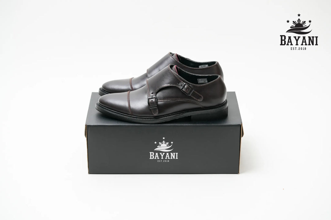 Black leather shoes on a black box with Bayani logo on a white background
