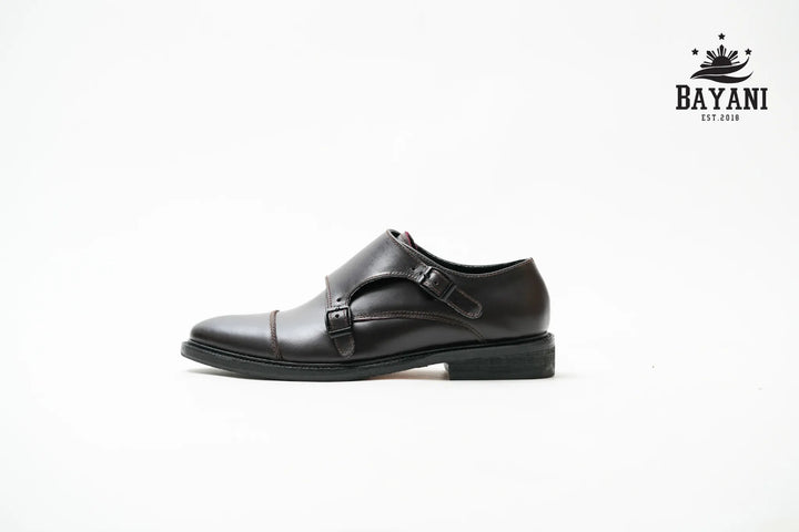 Black leather dress shoe with a Bayani logo on a white background

