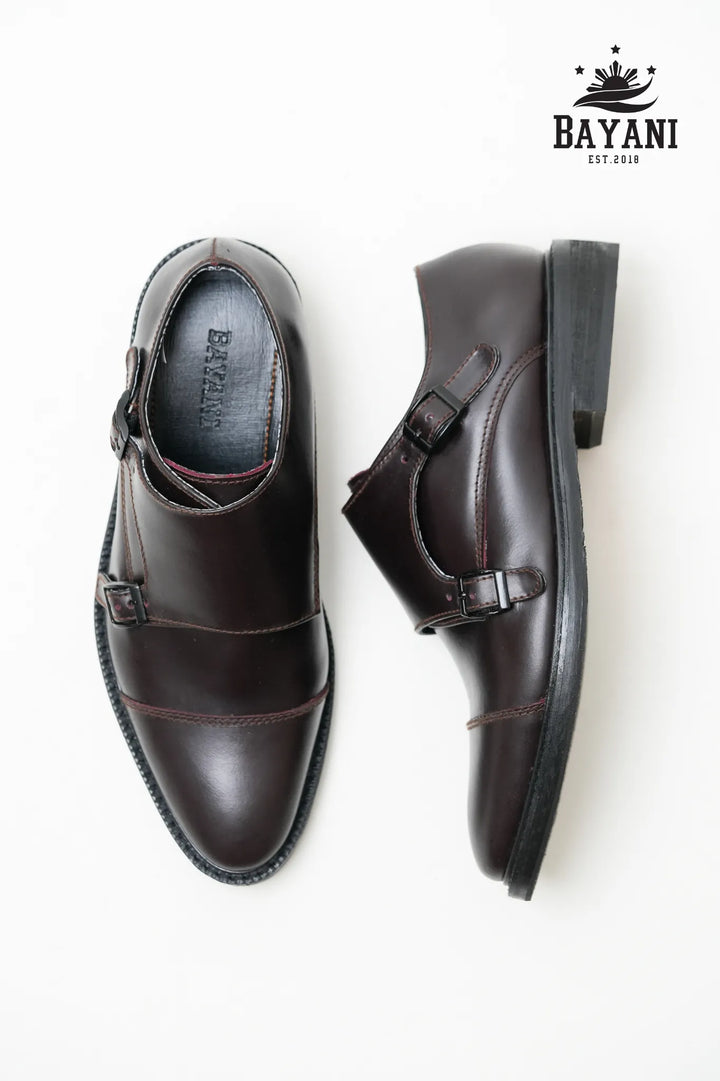 Brown monk strap shoes on a white background with Bayani logo.
