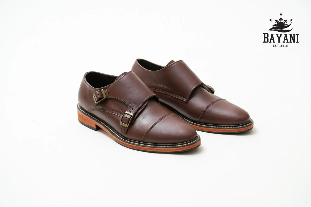 Black dress shoes on a white background with Bayani logo.
