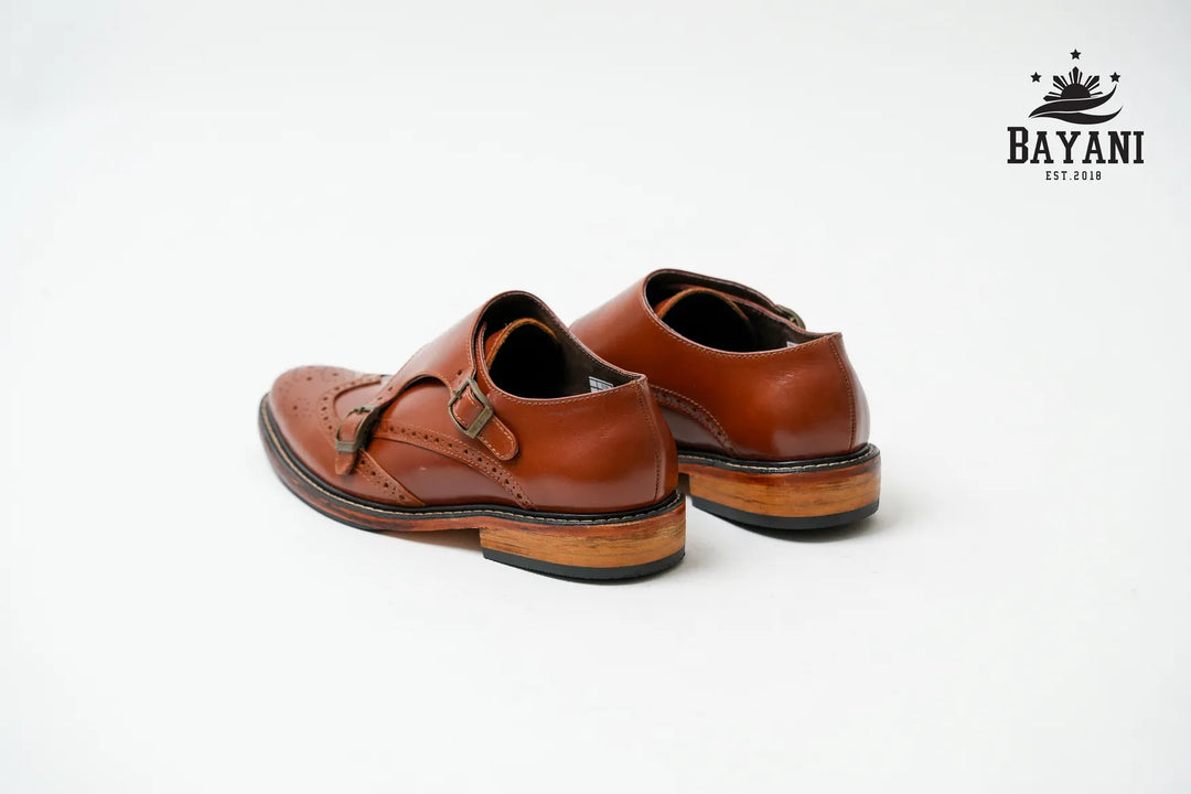 Pair of brown leather shoes on a white background with Bayani logo.
