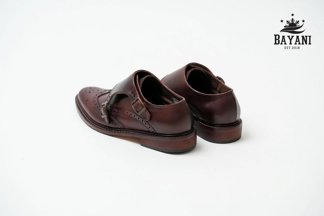 Pair of brown leather shoes on a white background with Bayani logo.

