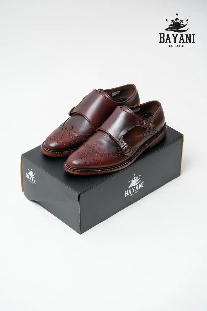 Brown leather shoes on a black Bayani box with the brand logo.
