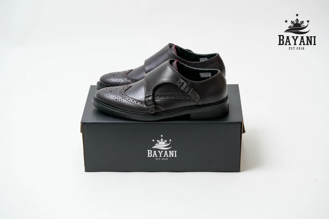 Black shoes on a black box with Bayani logo on a white background
