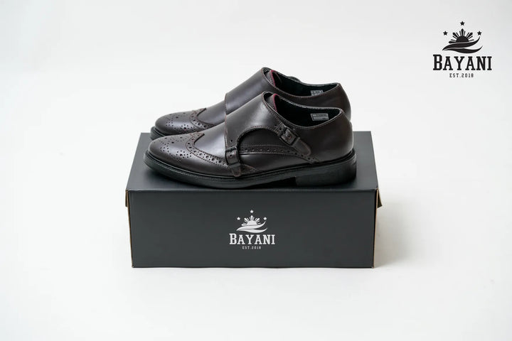 Black shoes on a black box with Bayani logo on a white background
