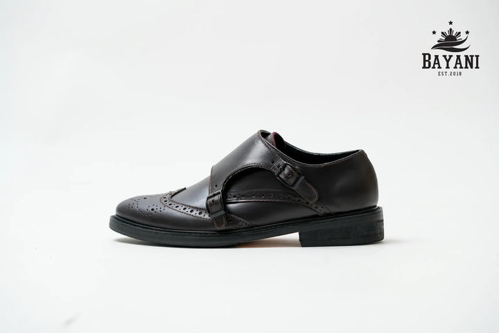 Black shoe with a strap on a white background, featuring the Bayani logo.
