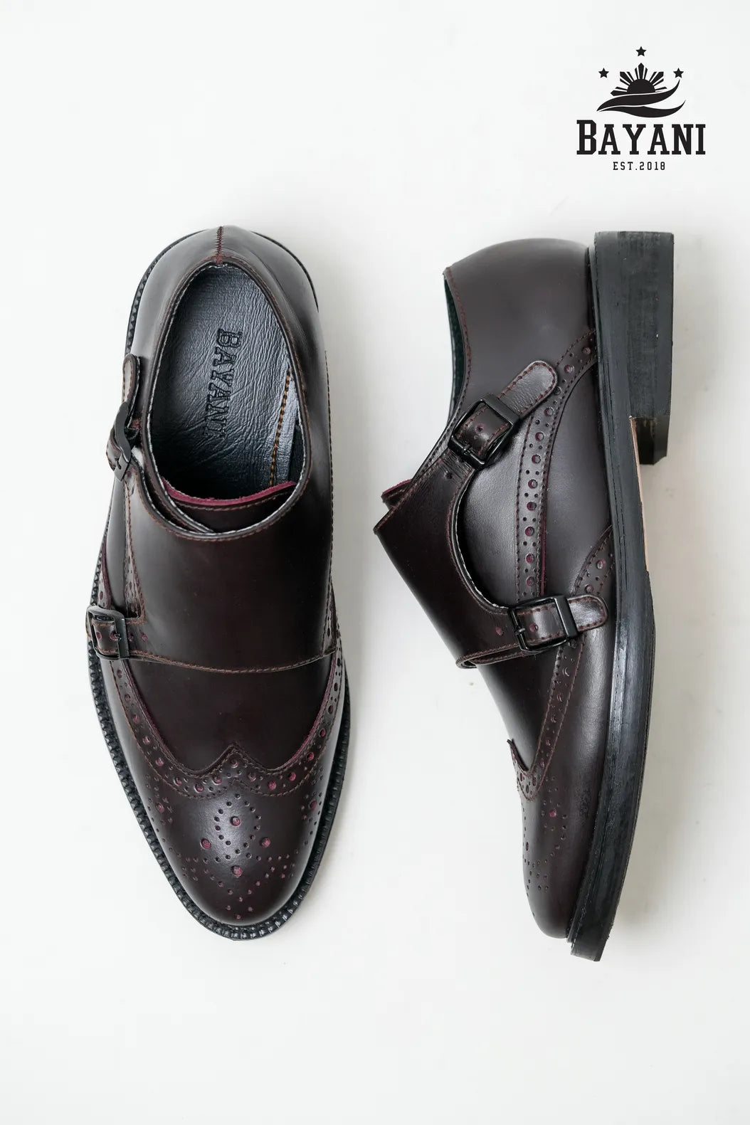 Brown dress shoes with a Bayani logo on a white background
