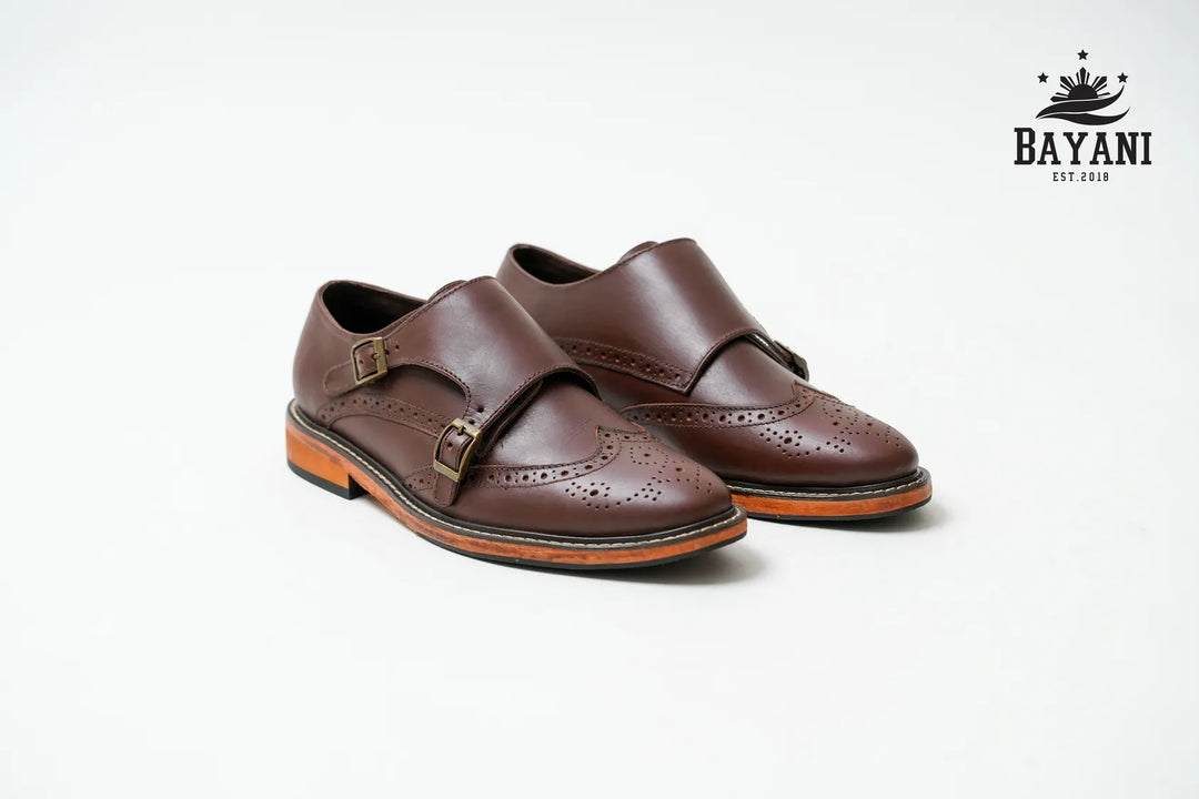 Pair of brown leather shoes with a visible brand logo on a white background
