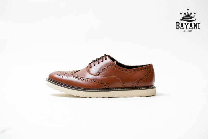 Brown leather shoe on a white background with Bayani logo.
