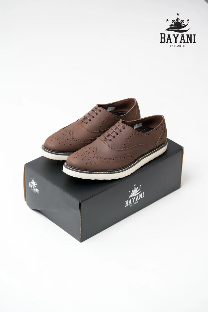 Brown shoes on a Bayani box with the Bayani logo above.
