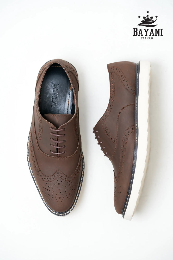 Brown dress shoes with white soles on a white background, featuring the Bayani brand.
