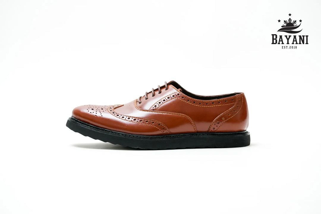 Brown leather shoe on a white background with Bayani logo.
