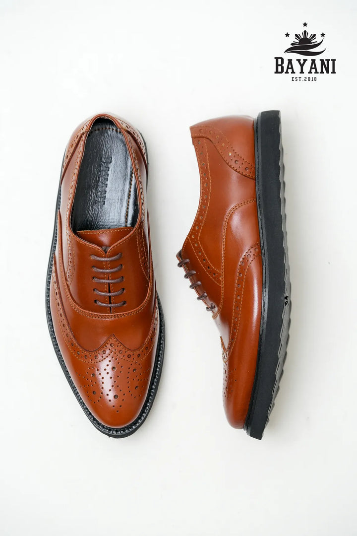 Brown leather shoes with black soles on a white background, featuring the Bayani brand logo.
