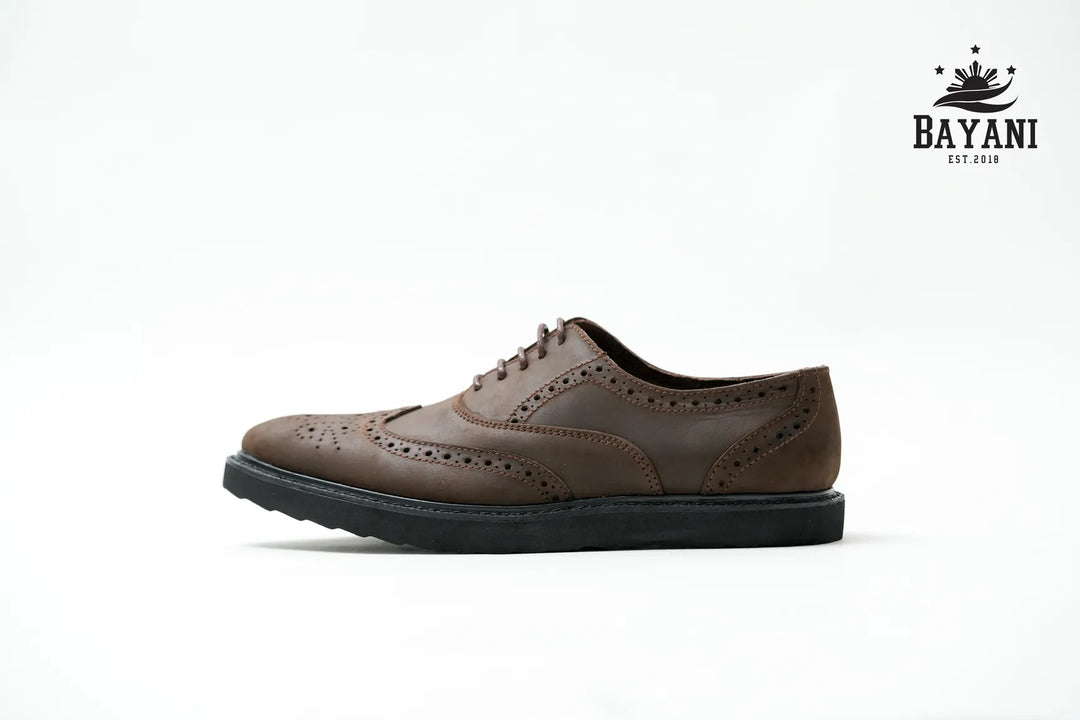 Brown leather shoe on a white background with Bayani logo.
