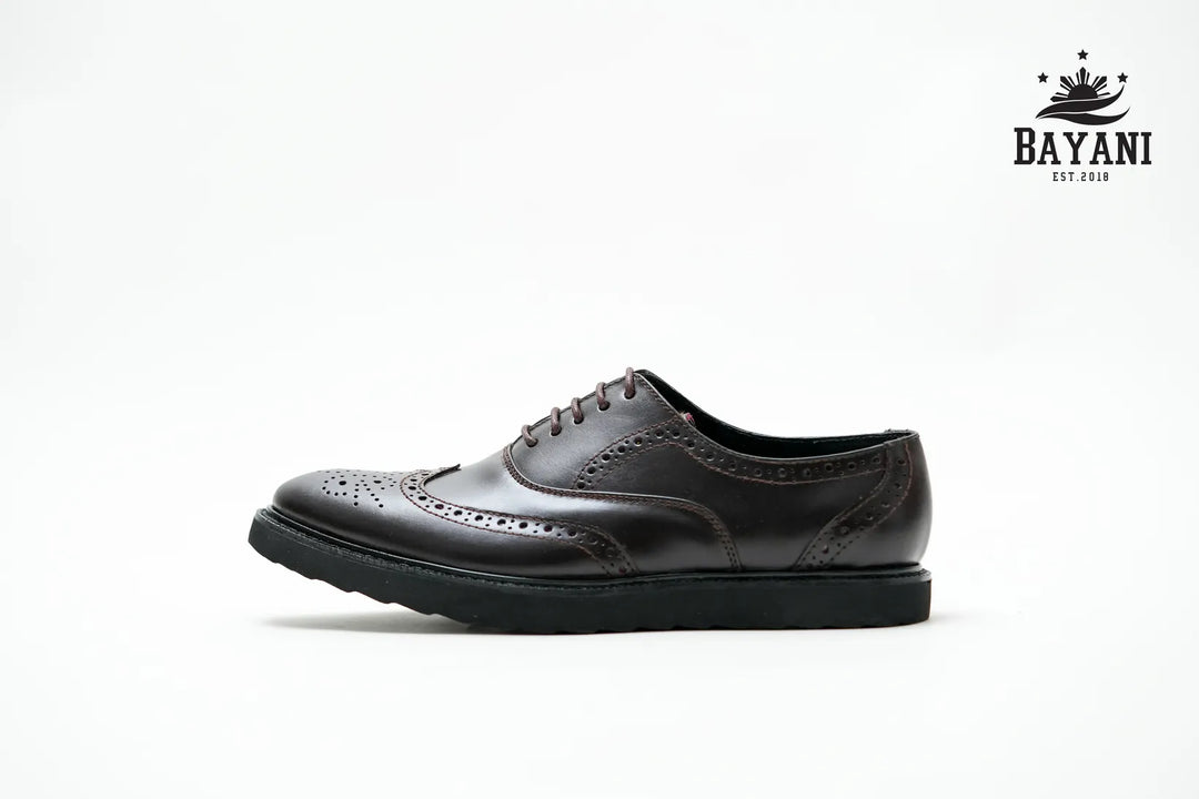 Black leather shoe on a white background with Bayani logo.
