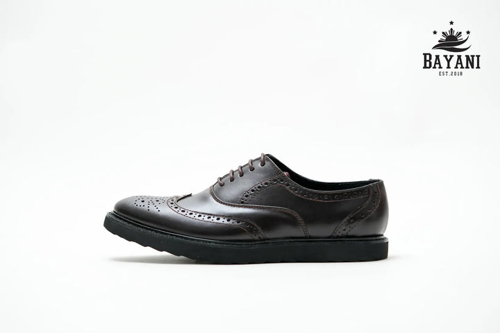 Black leather shoe on a white background with Bayani logo.
